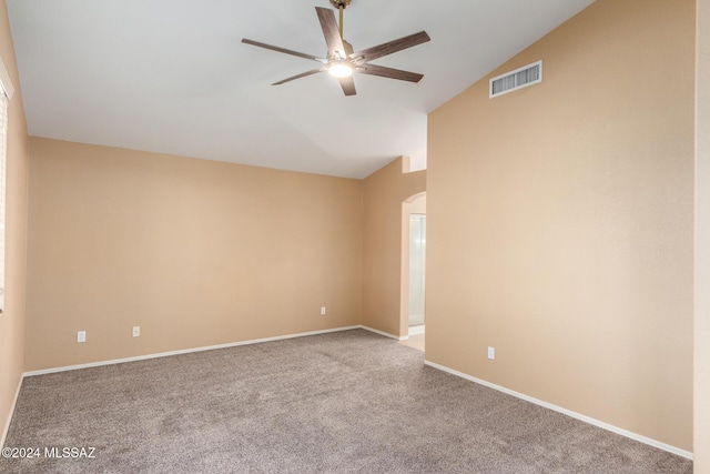 carpeted empty room featuring lofted ceiling and ceiling fan