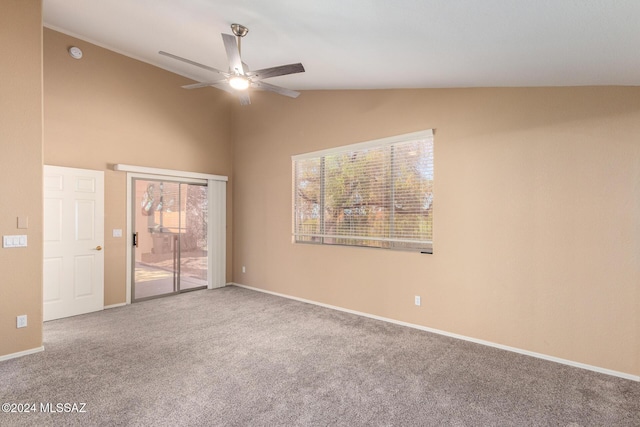 empty room with ceiling fan, vaulted ceiling, and carpet flooring