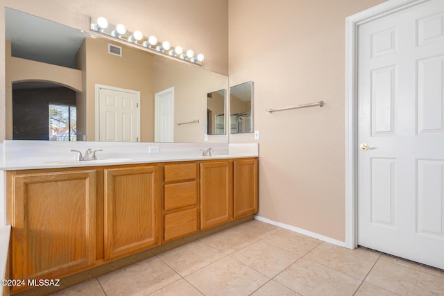 bathroom with tile patterned flooring and vanity