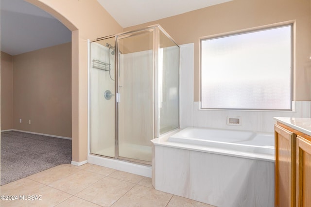 bathroom featuring tile patterned floors, vanity, and plus walk in shower