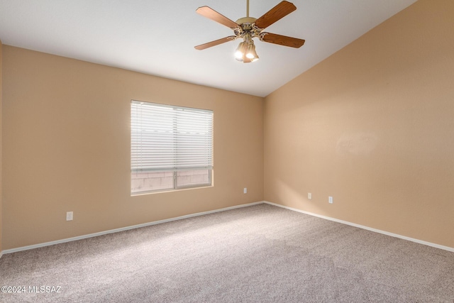 carpeted spare room with ceiling fan and lofted ceiling