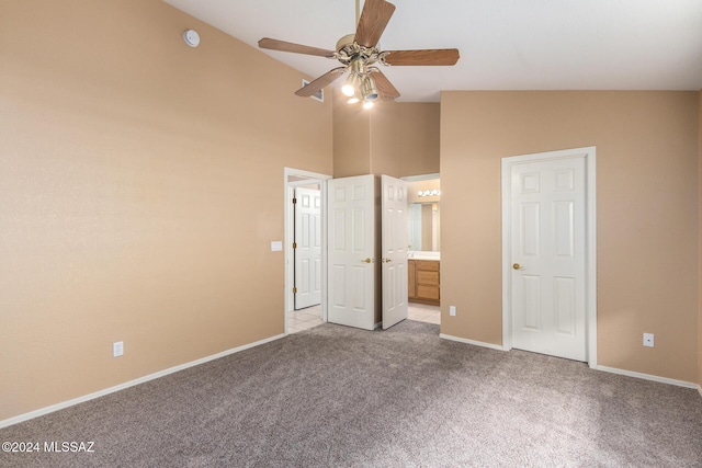 unfurnished bedroom with light carpet, ceiling fan, lofted ceiling, and ensuite bath