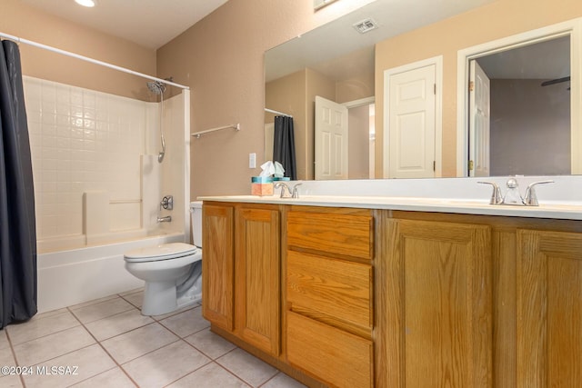 full bathroom featuring toilet, vanity, tile patterned flooring, and shower / bath combo with shower curtain