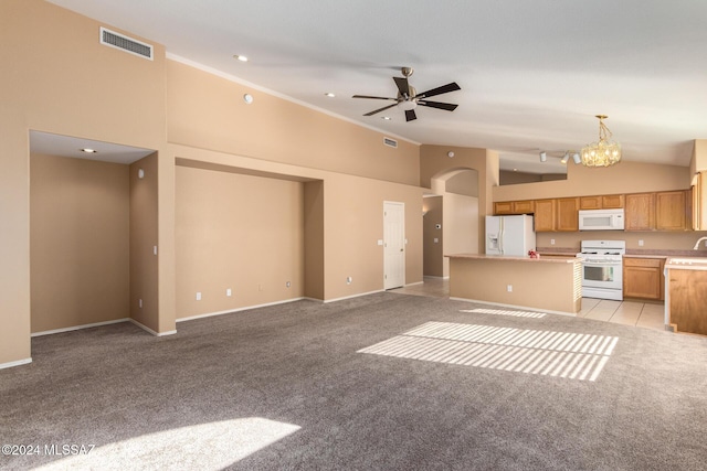 kitchen featuring pendant lighting, light colored carpet, white appliances, and high vaulted ceiling