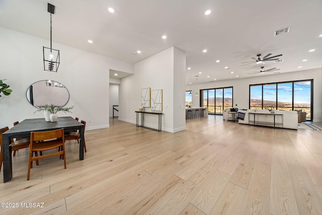 living room featuring ceiling fan and light hardwood / wood-style flooring