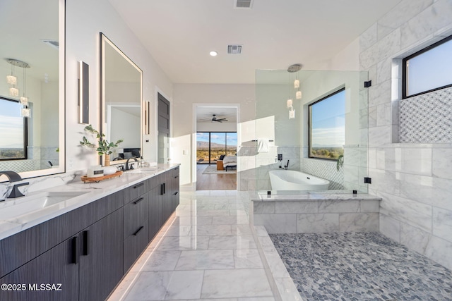 bathroom featuring vanity, ceiling fan, and plus walk in shower