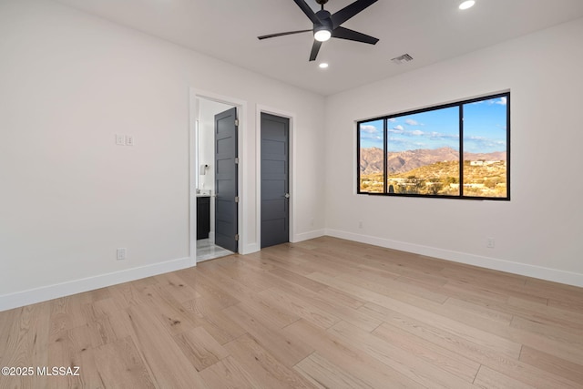 unfurnished bedroom with ceiling fan, light hardwood / wood-style floors, and ensuite bath