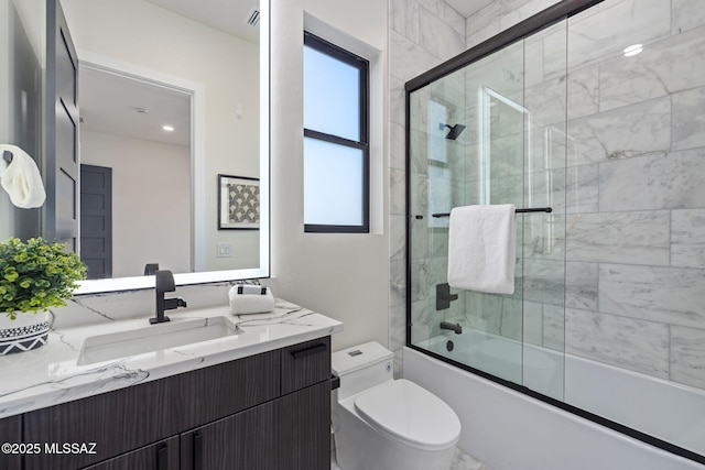 full bathroom with toilet, vanity, and combined bath / shower with glass door