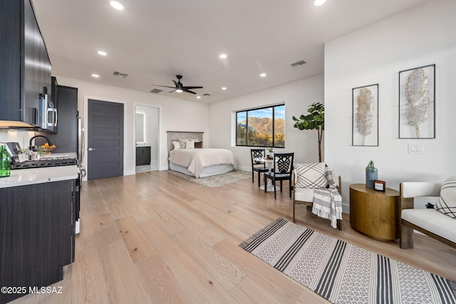 bedroom featuring light hardwood / wood-style floors and connected bathroom