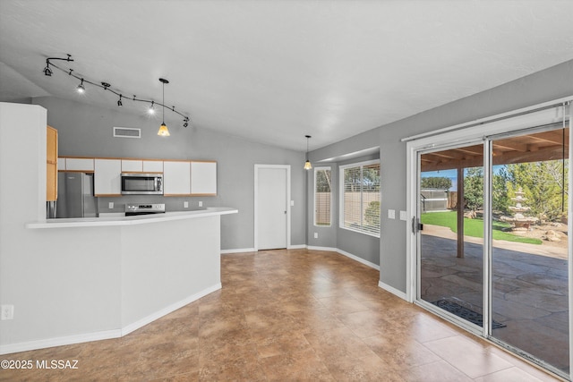 kitchen with stainless steel appliances, vaulted ceiling, white cabinets, and decorative light fixtures