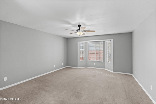 empty room with light colored carpet and ceiling fan