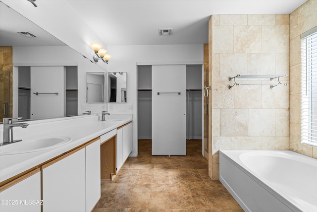 bathroom featuring vanity, tile walls, and a washtub