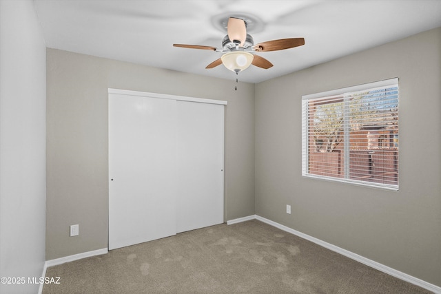 empty room featuring ceiling fan and carpet flooring