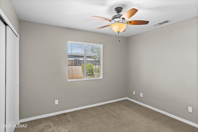 unfurnished bedroom with carpet flooring, ceiling fan, and a closet