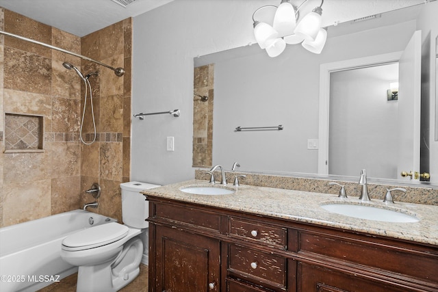 full bathroom with vanity, tiled shower / bath combo, and toilet