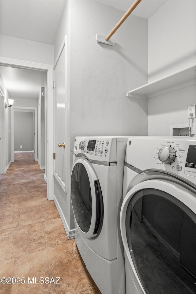 laundry area with washing machine and clothes dryer