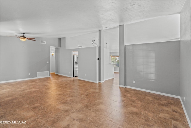 unfurnished living room featuring vaulted ceiling and ceiling fan