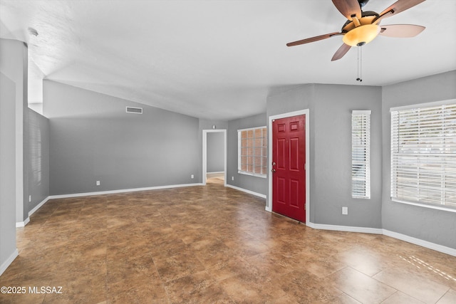 unfurnished living room with ceiling fan and vaulted ceiling