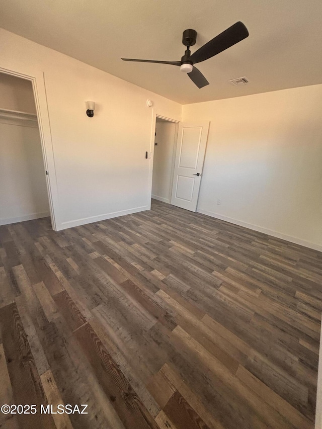 unfurnished bedroom with ceiling fan, a closet, and dark hardwood / wood-style flooring