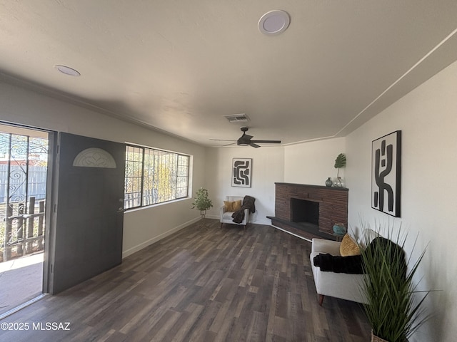 living room featuring ceiling fan and dark hardwood / wood-style flooring