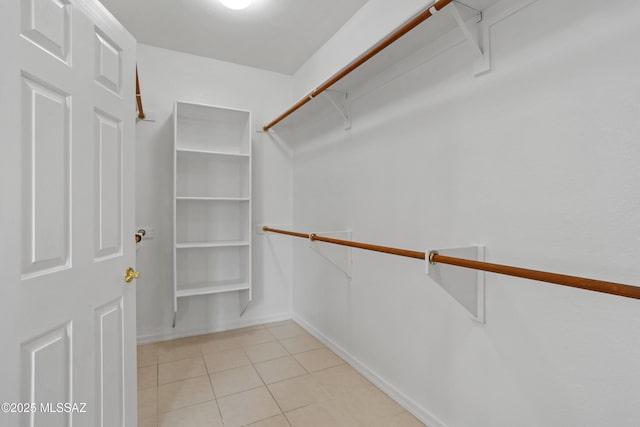 walk in closet featuring light tile patterned flooring