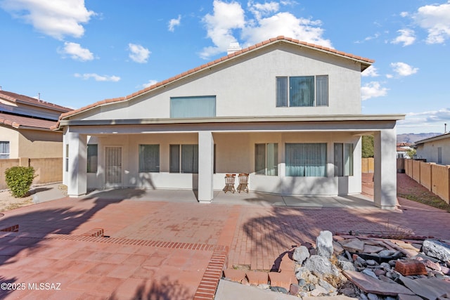 back of property with a patio