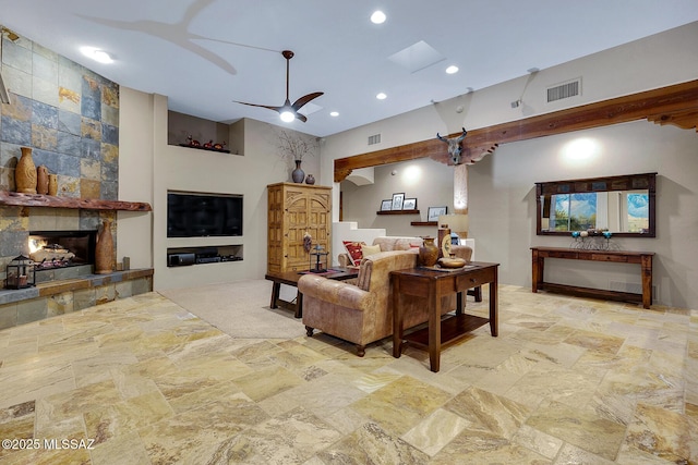 living room with ceiling fan and a fireplace