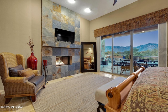 bedroom with access to exterior and a fireplace