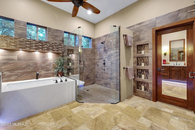 bathroom featuring ceiling fan, vanity, and separate shower and tub