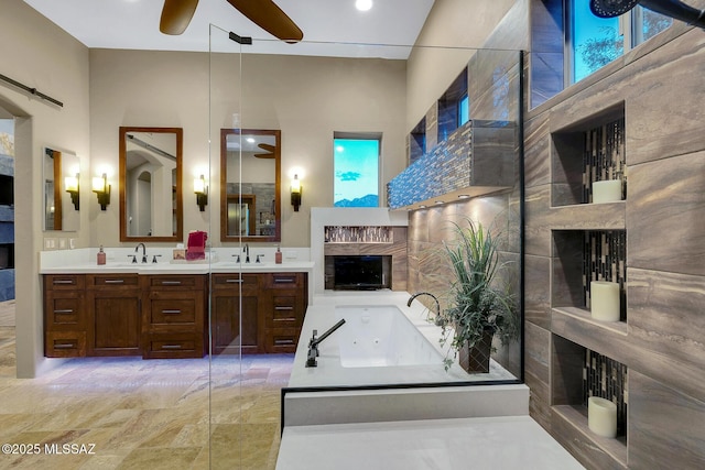 bathroom featuring vanity, a wealth of natural light, a bath, and ceiling fan