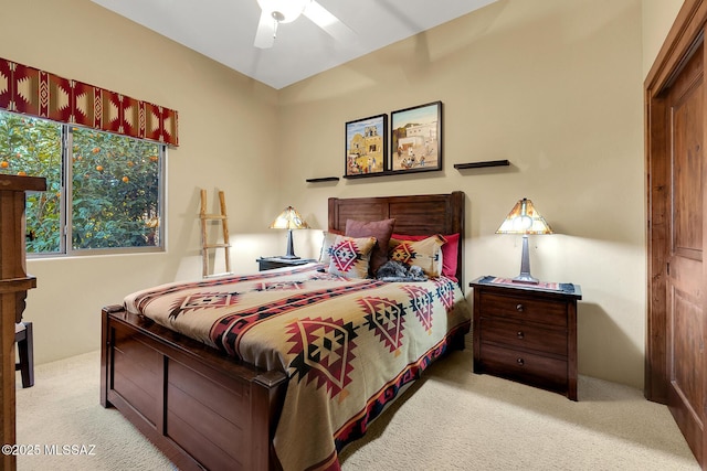 bedroom featuring light colored carpet and ceiling fan