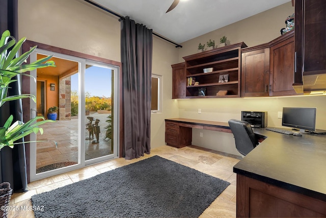 home office with ceiling fan and built in desk