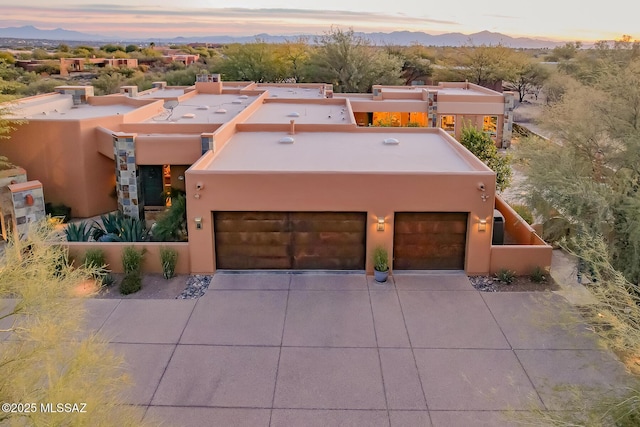 view of front facade with a garage and a mountain view