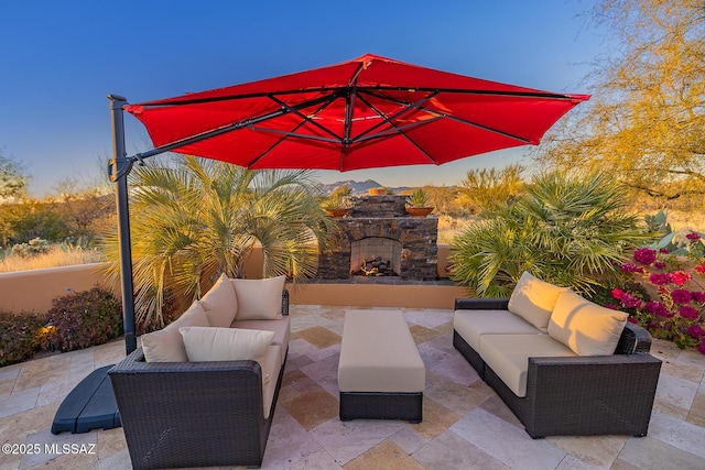 view of patio featuring an outdoor living space with a fireplace