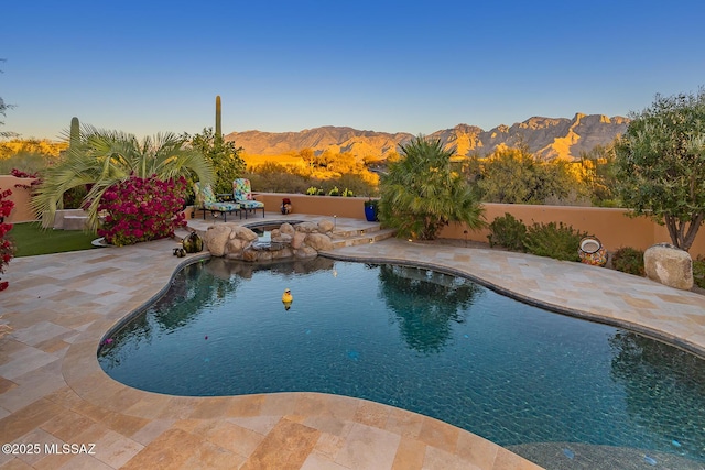 view of swimming pool featuring a mountain view and a patio area