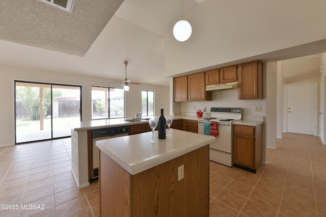 kitchen featuring a peninsula, white electric range oven, dishwasher, and light tile patterned floors