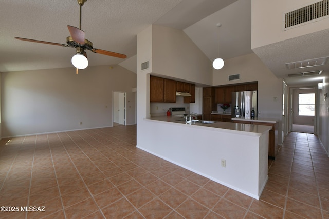 kitchen featuring under cabinet range hood, stainless steel fridge with ice dispenser, visible vents, and light tile patterned floors