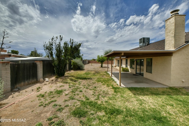 view of yard featuring a fenced backyard, a patio, and central air condition unit