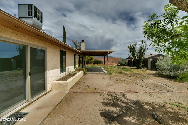 view of yard featuring fence and a patio