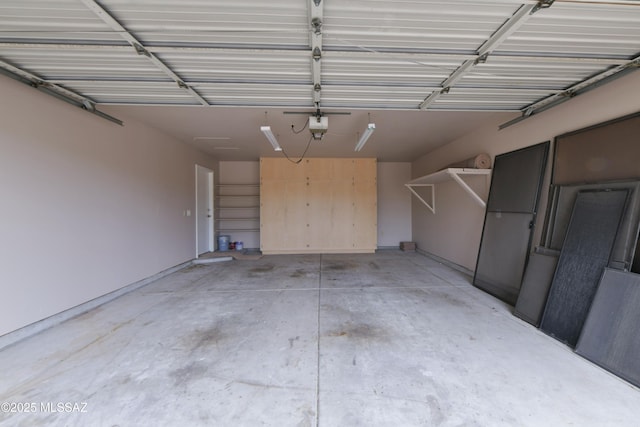 garage with a garage door opener and baseboards