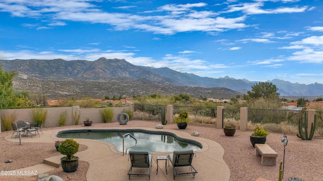 view of swimming pool featuring a mountain view and a patio