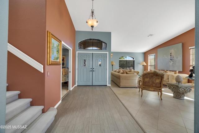 foyer featuring lofted ceiling and light wood-type flooring