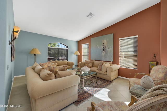 living room featuring lofted ceiling and light tile patterned floors