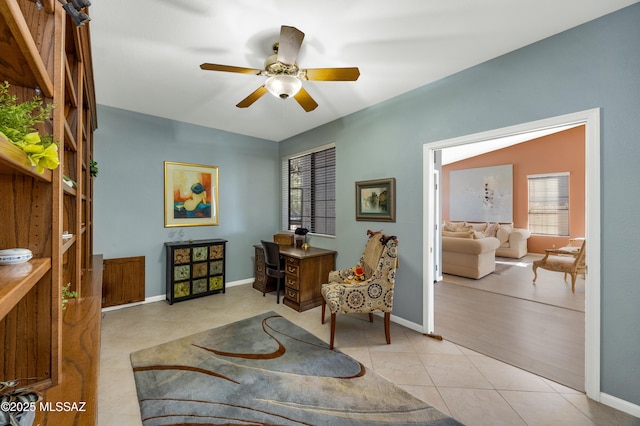 living area with light tile patterned flooring and ceiling fan