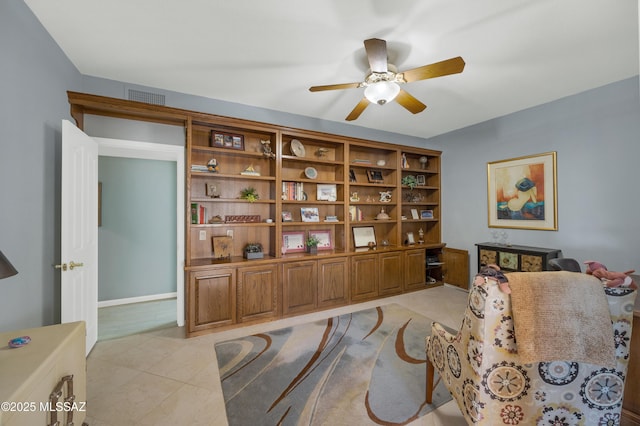 sitting room with light tile patterned floors and ceiling fan