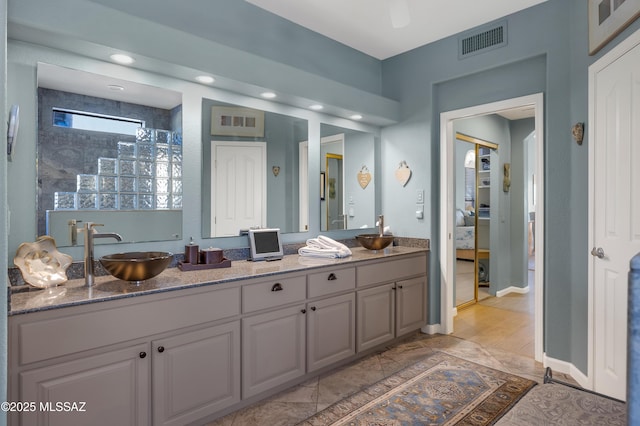 bathroom with walk in shower and vanity