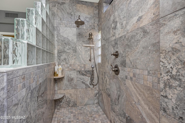 bathroom with a tile shower