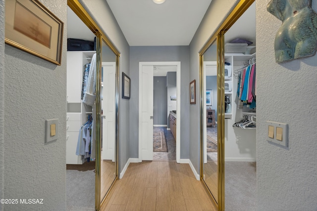 hallway with light wood-type flooring