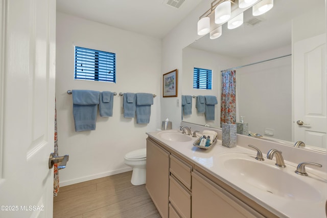 bathroom with vanity, curtained shower, and toilet