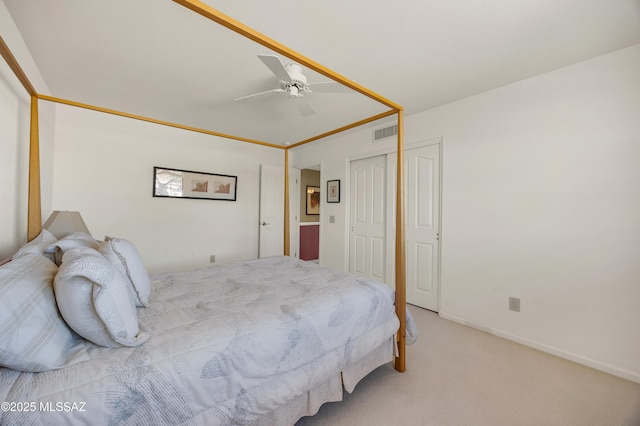 carpeted bedroom with ceiling fan and a closet